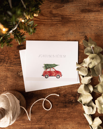 Cartes des fêtes avec images d'une voiture avec un sapin de noël